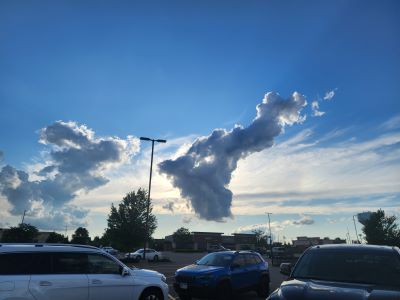 A picture of a cloud from a parking lot